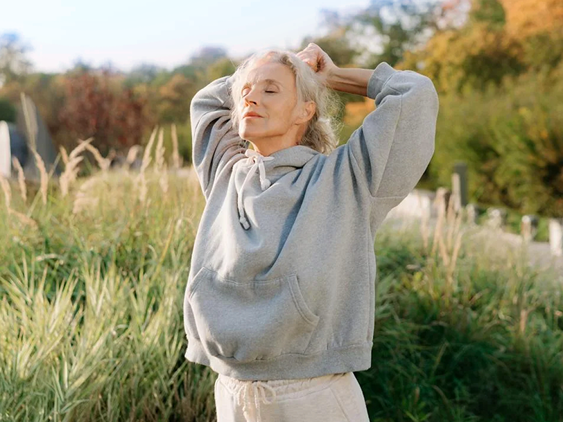 Older woman stretching outdoors