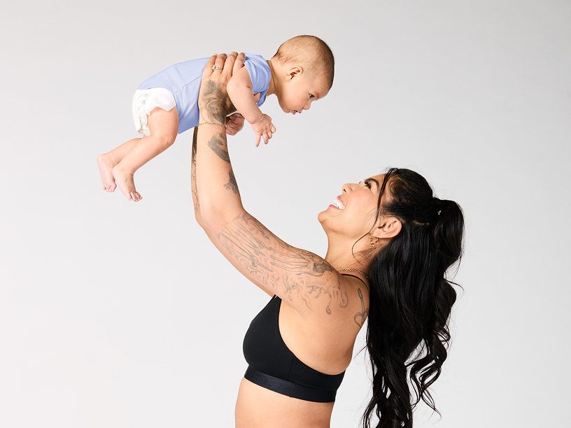 Mother holding up baby