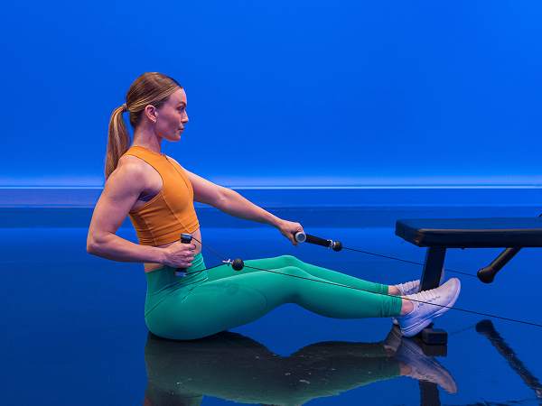 Tonal instructor on ground doing seated row
