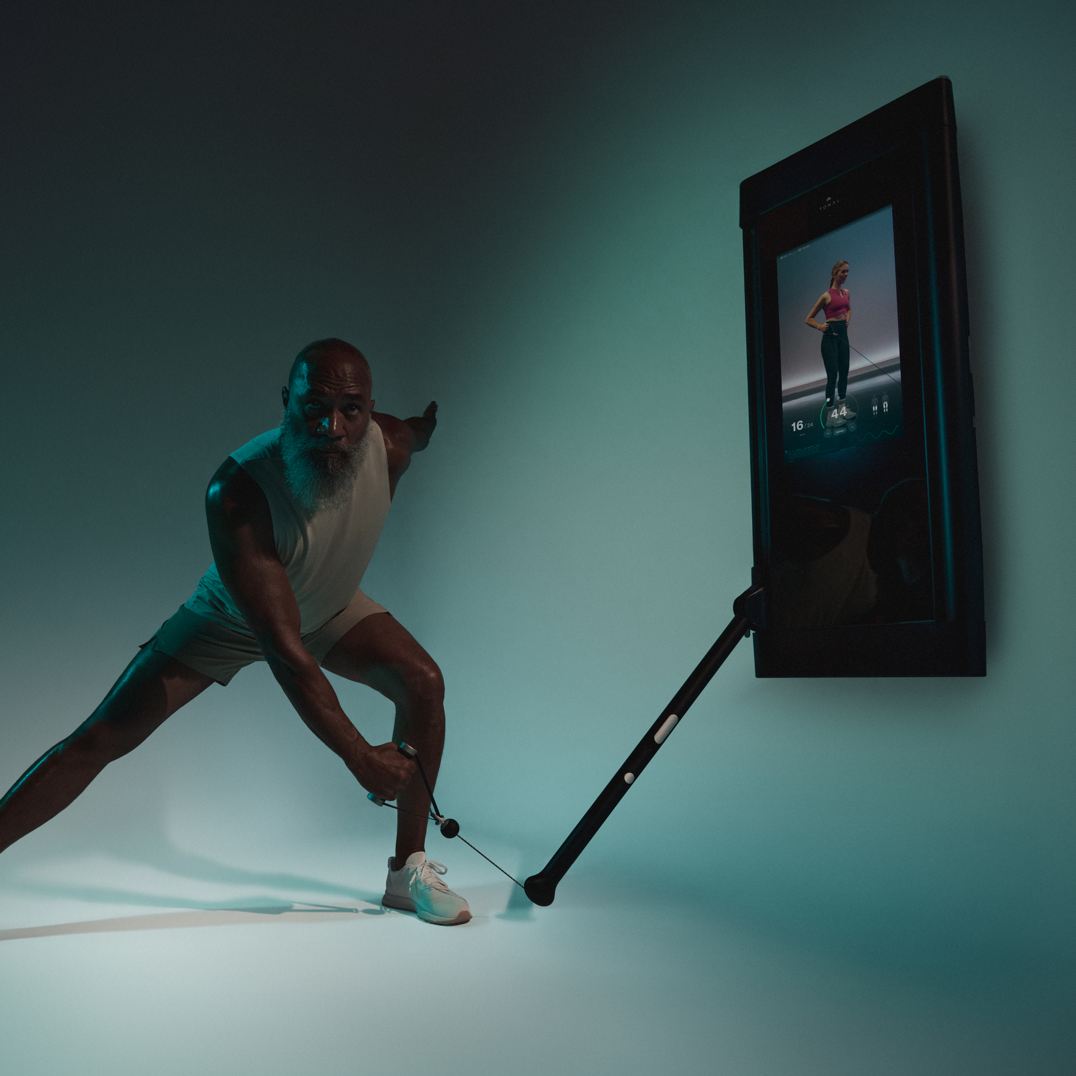 Man looking past camera doing resisted lateral lunge