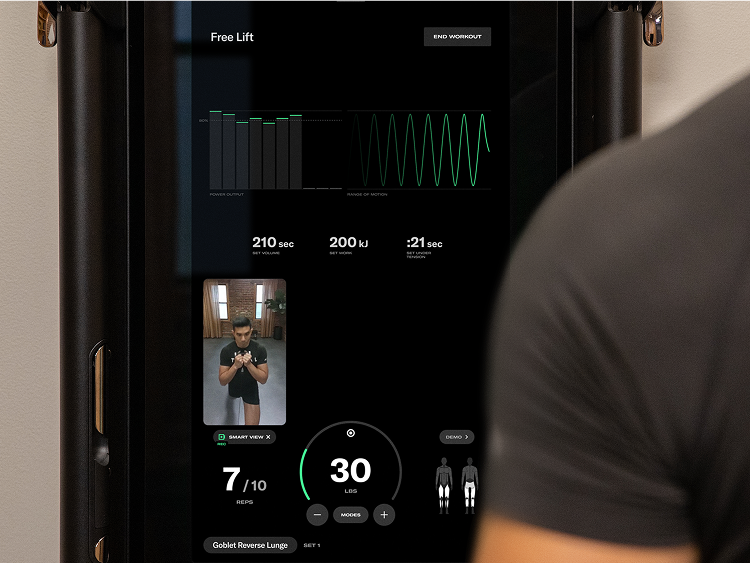 Man in front of Tonal system showing personalized stats