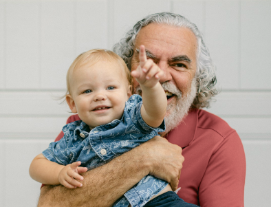 Older man holding his grandchild