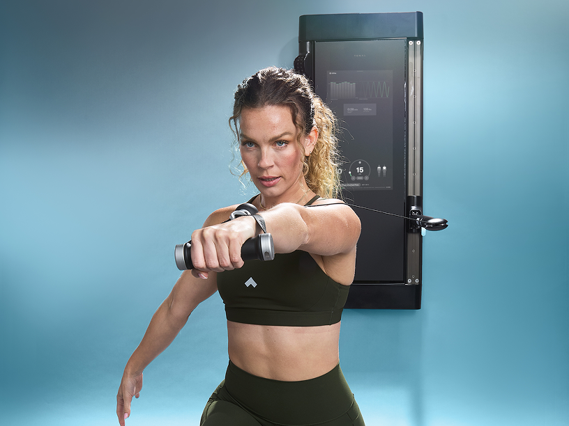 Tonal instructor doing standing chest press