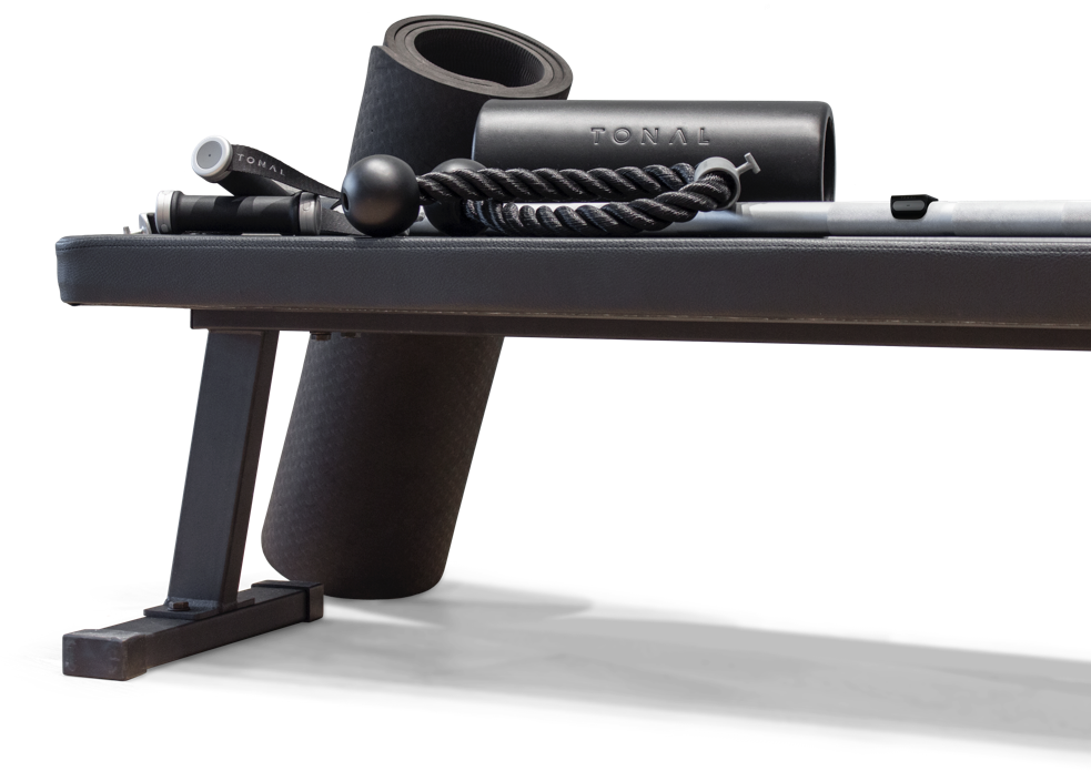 Black tonal workout bench, black workout mat, black workout roller, and black rope attachments