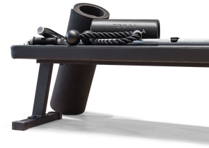 Black tonal workout bench, black workout mat, black workout roller, and black rope attachments